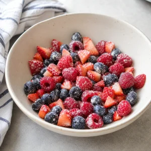 Strawberries, blueberries, and raspberries lightly coated with flour