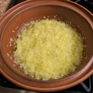 Onion softening in olive oil in a tagine base