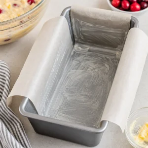 Greased loaf pan lined with parchment paper