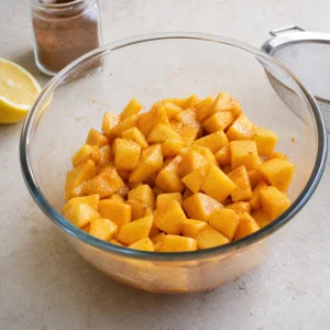Diced peaches coated with lemon, sugar, starch, and cinnamon