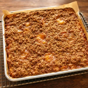 Golden peach slab pie bubbling in the pan