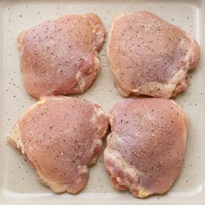 Chicken thighs seasoned with salt and black pepper