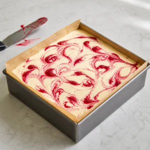 Final filling layer smoothed and marbled with raspberry