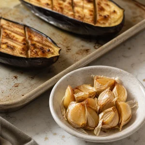 Soft roasted garlic cloves set aside before they burn