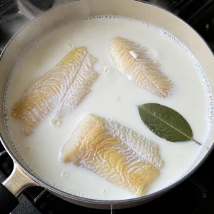 Geräucherte Schellfischfilets pochieren in Milch mit Lorbeerblatt