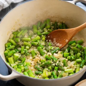 Garlic and chopped asparagus stalks sauteed with onion