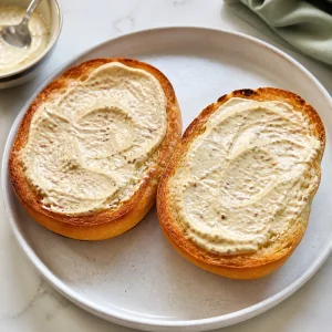 Dijon horseradish mayo spread on toasted roll halves