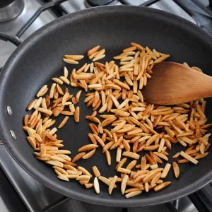 Slivered almonds toasting in a dry skillet