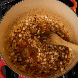 Onions and BBQ sauce base cooking in the Dutch oven