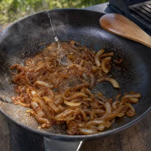 Deeply browned sliced onions in a skillet