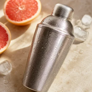Sealed cocktail shaker chilled with condensation after shaking
