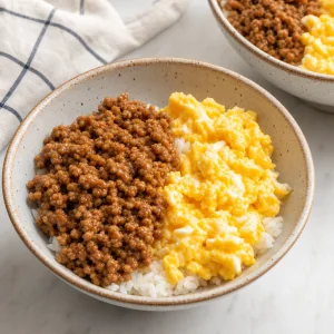 Soboro donburi bowl assembled with rice seasoned chicken and soft scrambled eggs