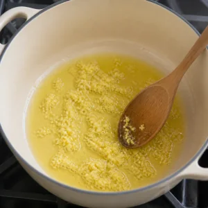 Grated ginger sizzling in olive oil