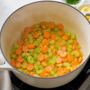 Carrots and celery softening in the soup pot