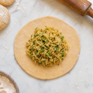 Mooli filling placed in the center of a small rolled dough circle.
