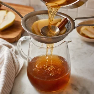 Pear tea strained through a fine sieve into a pitcher