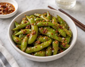 Spicy garlic chili edamame served with toasted sesame seeds