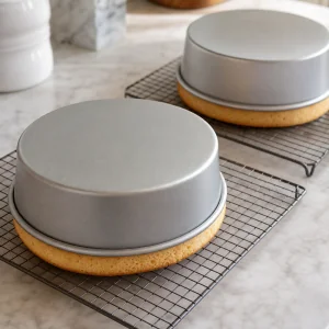 Baked chiffon cake layers cooling upside down on racks