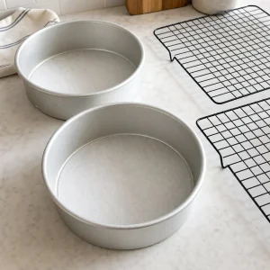 Cake pans lined with parchment and cooling racks prepared
