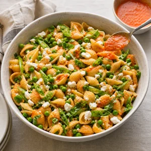 Served pasta salad refreshed with a spoonful of red pepper dressing