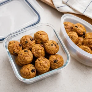 Cooled mini muffins packed in an airtight container