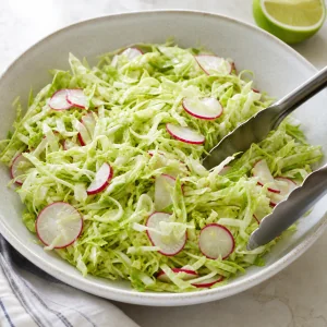 Crisp shredded cabbage and radish mixture with lime
