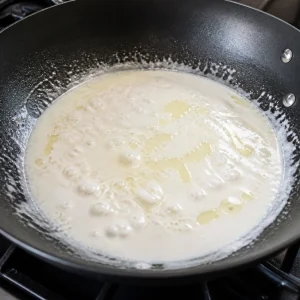 Coconut cream bubbling with oil in a wok