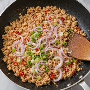 Shallots and scallions folded into seasoned chicken