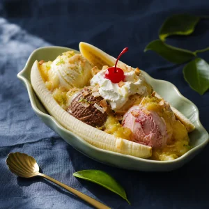 Toasted coconut banana split with pineapple sauce