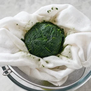 Cooked spinach squeezed dry in a kitchen towel