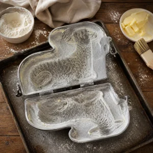 Floured lamb-shaped cake mold on a baking sheet
