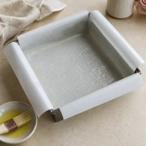 Parchment-lined square pan lightly greased for rose pistachio Turkish delight