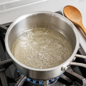 Sugar syrup bubbling in a small saucepan