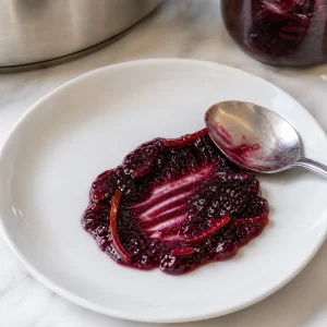 A spoonful of blueberry orange marmalade wrinkled on a chilled plate to test the set.