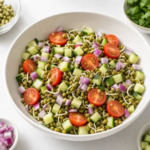 Mung bean sprouts mixed with cucumber, tomatoes, and red onion