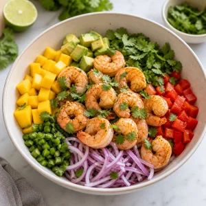 Cooked shrimp and fresh cilantro added to the mango avocado salad.